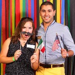 Man and woman smiling holding an Italian and United States of America flag